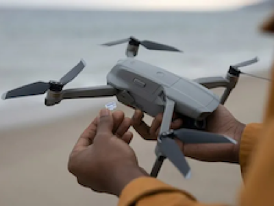 person-holding-drone-memory-card-feature-825x465