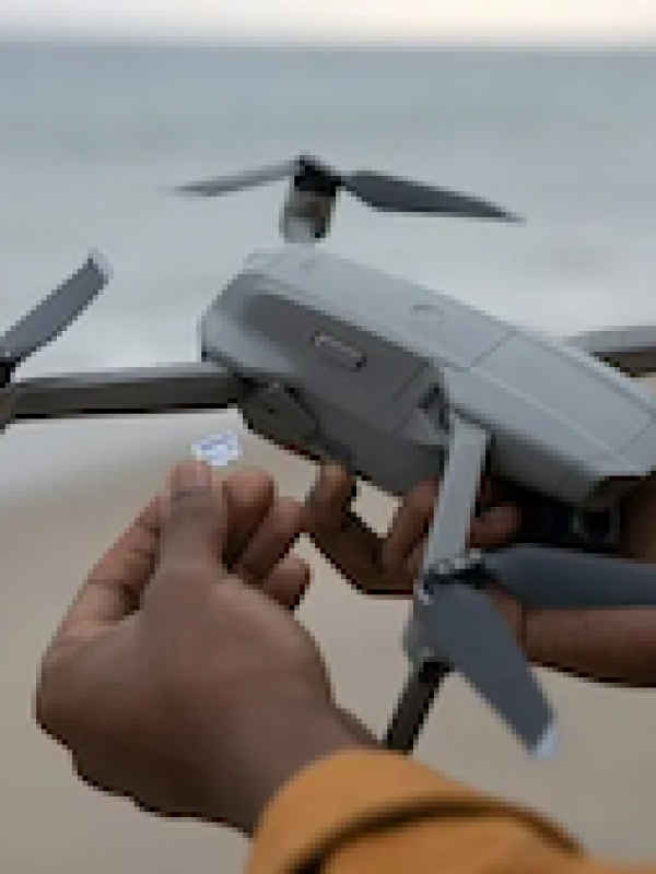 person-holding-drone-memory-card-feature-825x465